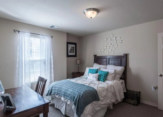 Bed desk chair and pillows bedroom at The Verge at Las Cruces in Las Cruces Student Accommodation