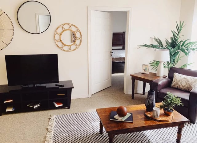 Brown leather chair TV and coffee table living room at The Verge at Las Cruces in Las Cruces Student Accommodation