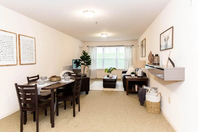 Dining table with chairs sofa and TV living room at Grove at Slippery Rock in Slippery Rock Student Accommodation
