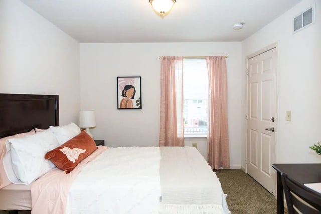 Bed pillows art picture window and door bedroom at Grove at Slippery Rock in Slippery Rock Student Accommodation
