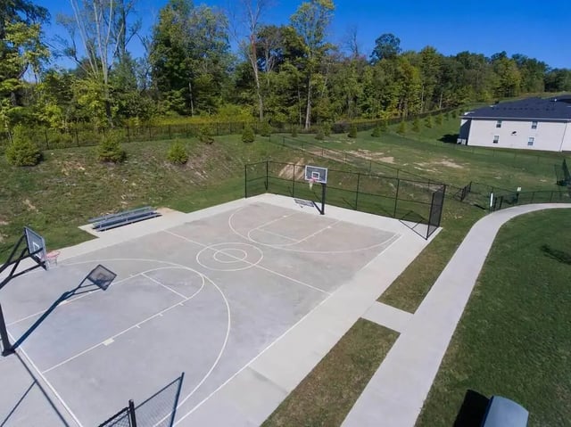 Basketball court with benches and trees exterior at Grove at Slippery Rock in Slippery Rock Student Accommodation