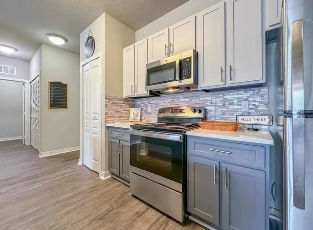 Modern kitchen with stainless steel appliances and gray cabinets kitchen at NXNW in Tallahassee Student Accommodation