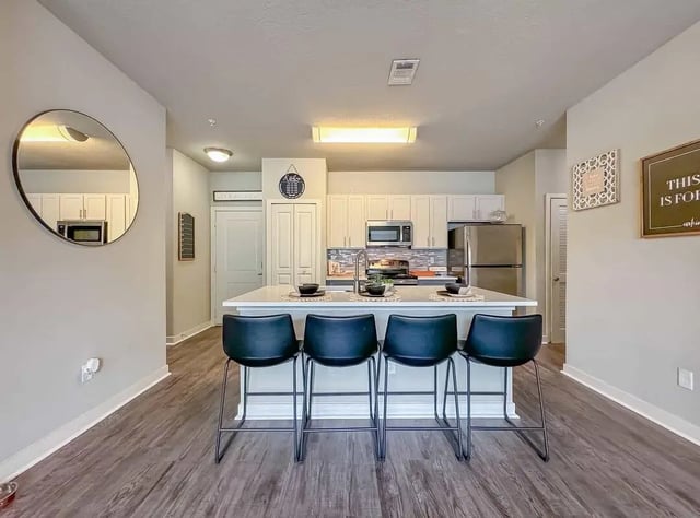 Island with bar stools stainless steel appliances kitchen at NXNW in Tallahassee Student Accommodation