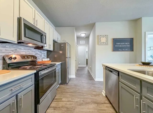 Modern kitchen with stainless steel appliances and cabinets kitchen at NXNW in Tallahassee Student Accommodation
