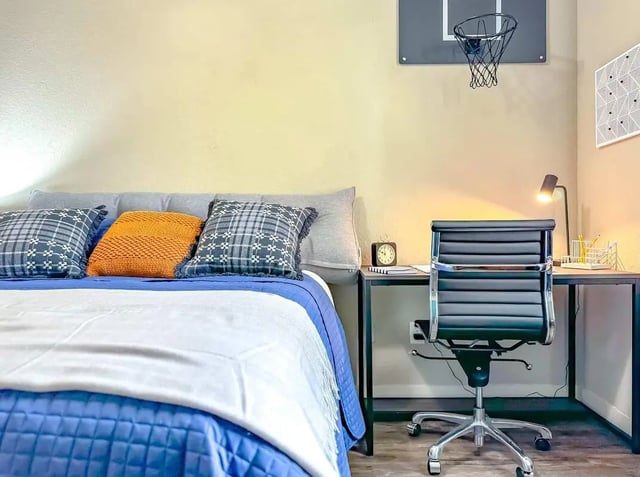 Bed pillows desk chair and basketball hoop bedroom at NXNW in Tallahassee Student Accommodation