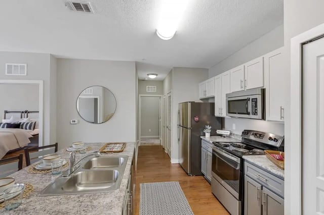 Stainless steel appliances circular mirror kitchen island kitchen at NXNW in Tallahassee Student Accommodation