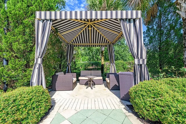 Striped cabana with seating and table outdoor living area at NXNW in Tallahassee Student Accommodation