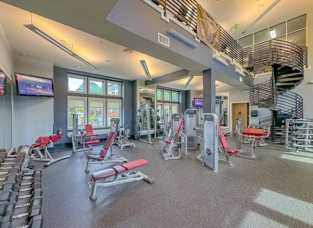 Gym equipment weight racks spiral staircase gym at NXNW in Tallahassee Student Accommodation