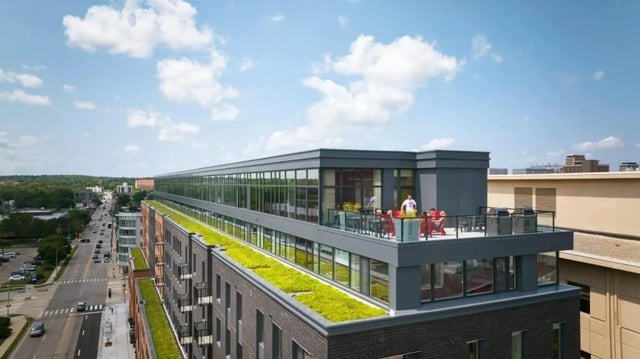 Rooftop patio furniture grills and people exterior at Chapter at Madison in Madison Student Accommodation