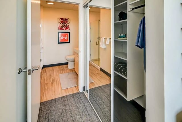 Toilet shower and closet with clothes Bathroom at Chapter at Madison in Madison Student Accommodation