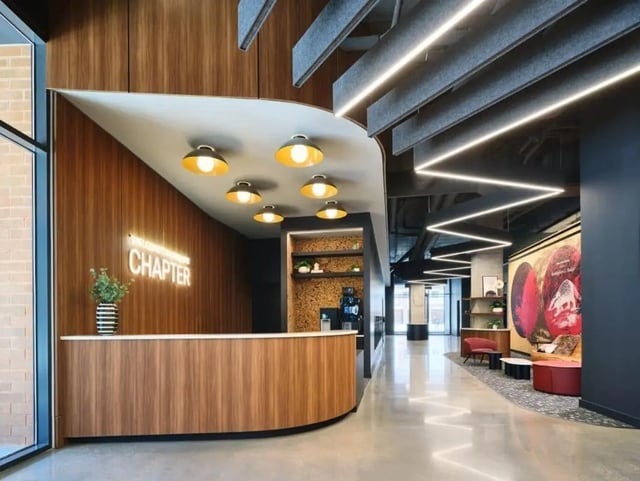 Reception desk neon sign and seating area lobby at Chapter at Madison in Madison Student Accommodation