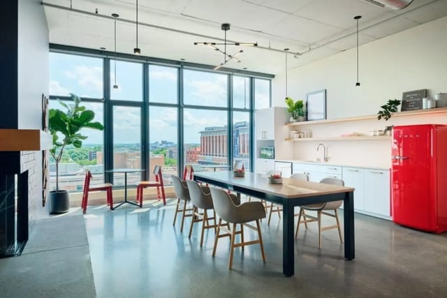 Dining table chairs plants red fridge kitchen area at Chapter at Madison in Madison Student Accommodation