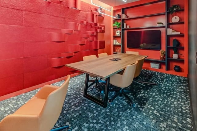 Conference room with red textured walls and table at Chapter at Madison in Madison Student Accommodation