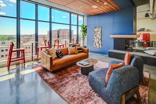 Sofa armchair rug coffee table fireplace living room at Chapter at Madison in Madison Student Accommodation