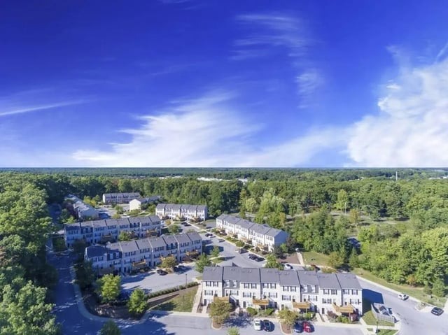 Townhouses with trees and blue sky exterior at State College Collective in State College Student Accommodation