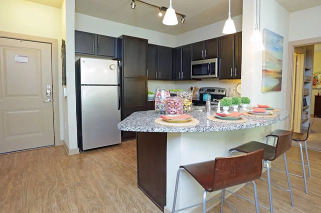 Fridge counter with stools and candy kitchen at The Lofts at City Center in Tuscaloosa Student Accommodation