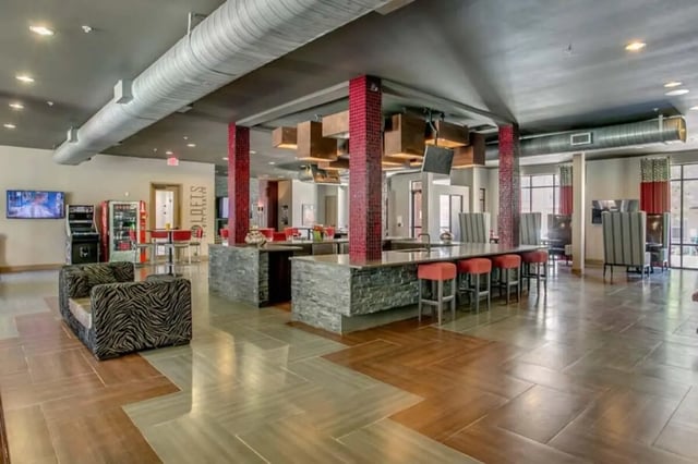 Zebra print sofa island bar with stools living room at The Lofts at City Center in Tuscaloosa Student Accommodation