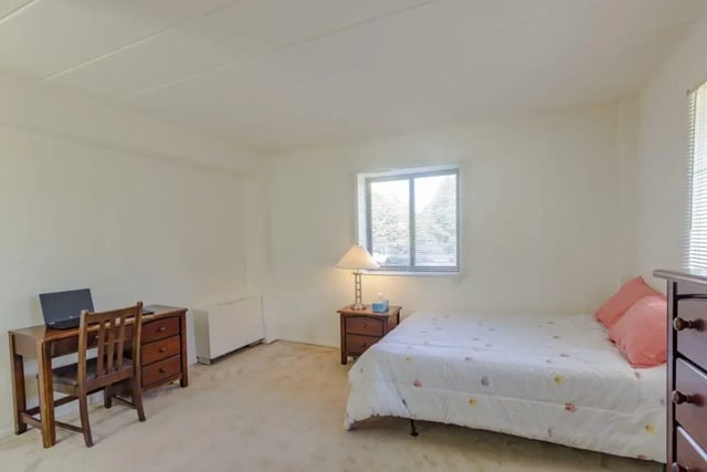 Bed desk nightstand lamp and dresser bedroom at Parkway Plaza in State College Student Accommodation