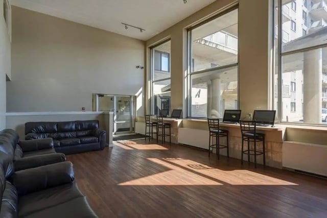 Leather couches and computer workstations common area at Parkway Plaza in State College Student Accommodation