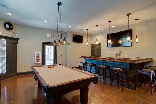 Pool table bar stools and TVs recreation area at Revelry Flats at Milledgeville in Milledgeville Student Accommodation
