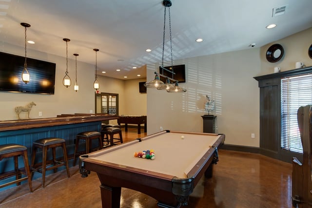 Pool table bar stools and foosball table game room at Revelry Flats at Milledgeville in Milledgeville Student Accommodation