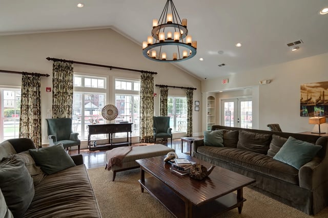Brown sofas coffee table chandelier living room at Revelry Flats at Milledgeville in Milledgeville Student Accommodation
