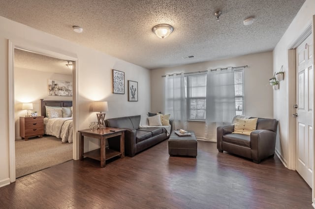 Leather sofa armchair ottoman living room at Revelry Flats at Milledgeville in Milledgeville Student Accommodation