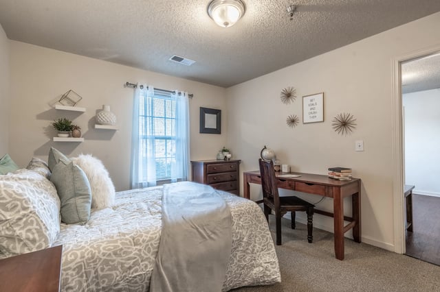 Bed desk chair shelves and dresser bedroom at Revelry Flats at Milledgeville in Milledgeville Student Accommodation