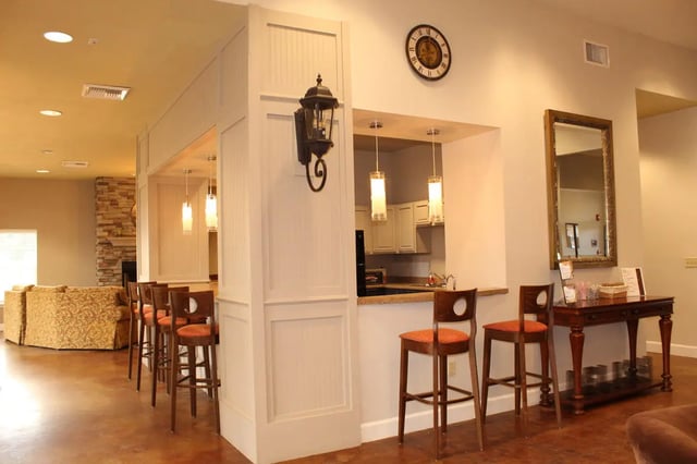 Bar stools kitchen cabinets and fireplace common area at Grove at Cheney in Pullman Student Accommodation