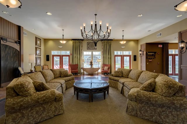 Patterned couches large oval coffee table living room at Grove at Cheney in Pullman Student Accommodation