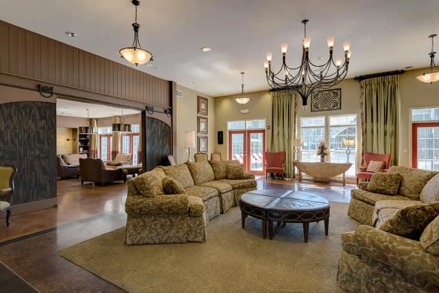 Floral couches large round coffee table living room at Grove at Cheney in Pullman Student Accommodation