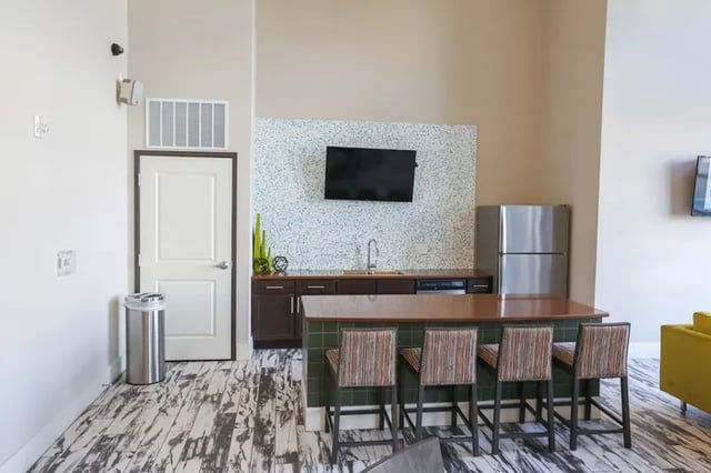 Kitchen with island four stools and refrigerator kitchen at Douglas Heights in Chattanooga Student Accommodation