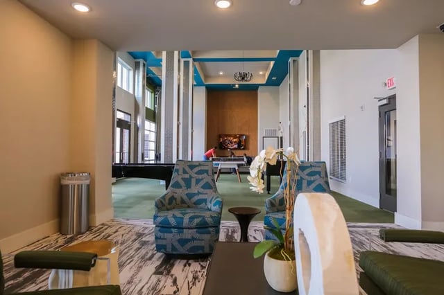 Pool table chairs television and exit sign common area at Douglas Heights in Chattanooga Student Accommodation