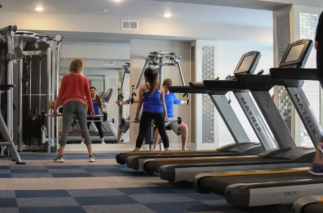 Treadmills weight machines and people working out gym at Douglas Heights in Chattanooga Student Accommodation
