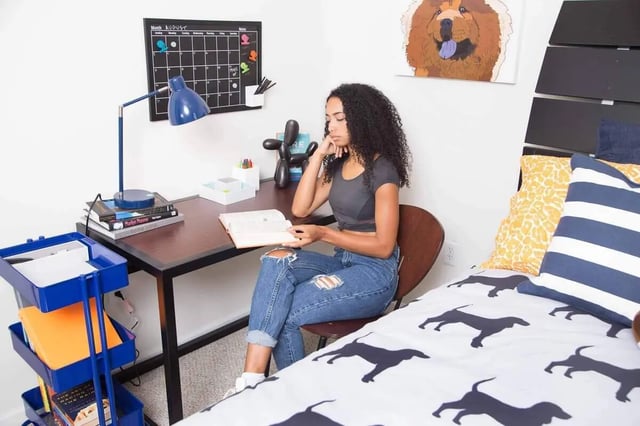 Woman at desk reading study area at Quarry Trail in Knoxville Student Accommodation