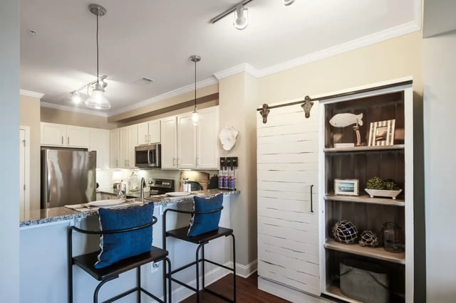 Kitchen with island and bar stools Barn door exterior at Sweetwater in Charleston Student Accommodation