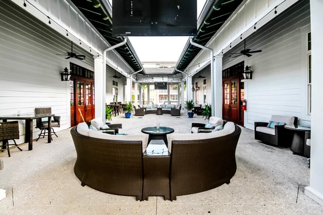 Wicker seating and tables outdoor courtyard area at Sweetwater in Charleston Student Accommodation