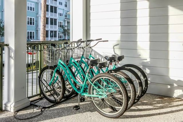 Aqua bicycles with baskets exterior. at Sweetwater in Charleston Student Accommodation