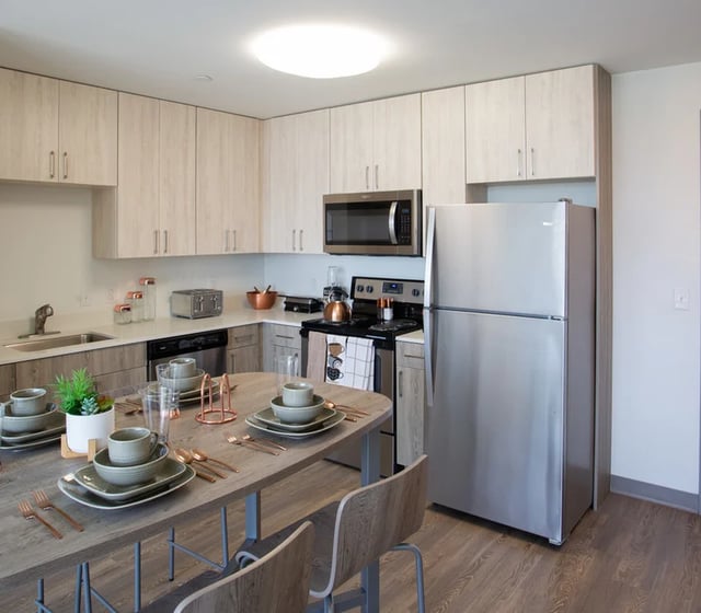Tableware on dining table facing kitchen area kitchen kitchen at Vantage in Philadelphia Student Accommodation