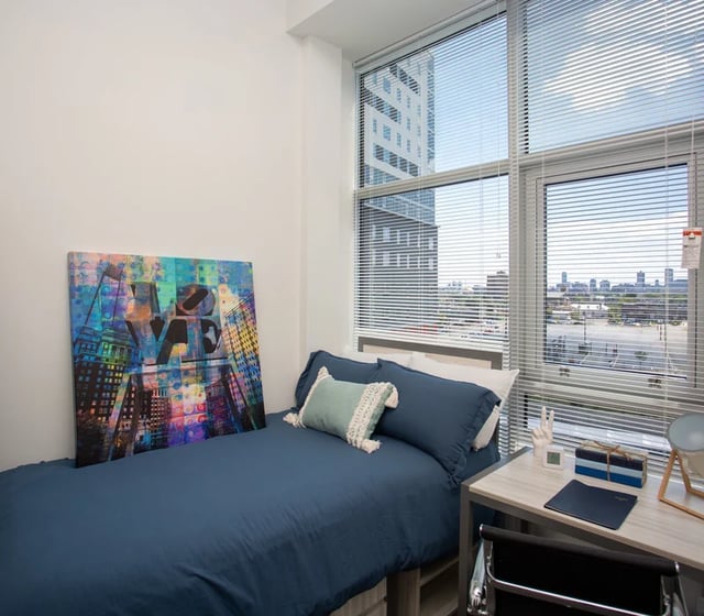 Bed artwork desk and chair bedroom at Vantage in Philadelphia Student Accommodation