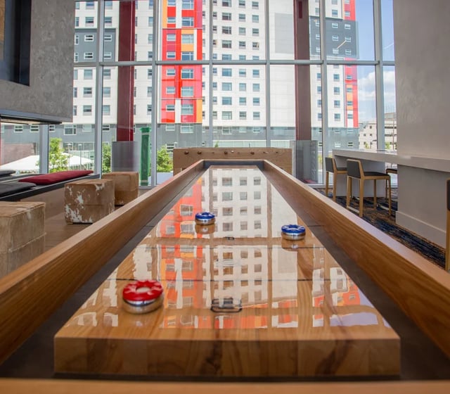 Shuffleboard table with pucks playing area at Vantage in Philadelphia Student Accommodation