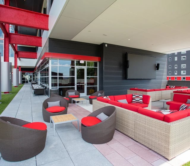 Outdoor lounge with red sofas and chairs patio at Vantage in Philadelphia Student Accommodation