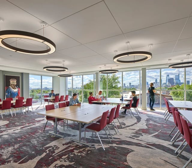 Study tables chairs artwork large windows common area at Vantage in Philadelphia Student Accommodation