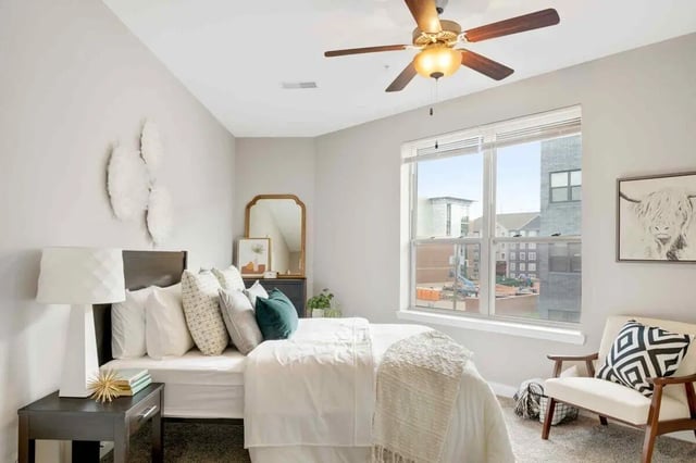 Bed with pillows mirror desk and chair bedroom at Midtown Stillwater in Stillwater Student Accommodation