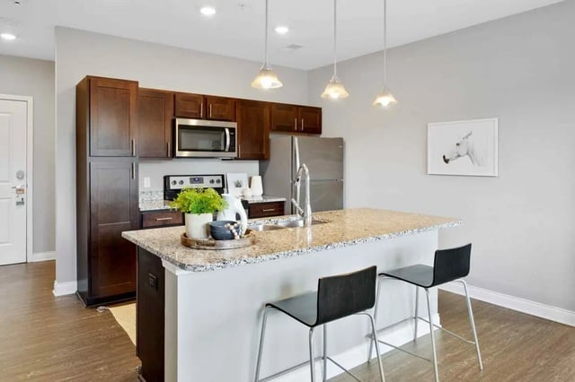 Modern kitchen island with stools and appliances Kitchen at Midtown Stillwater in Stillwater Student Accommodation
