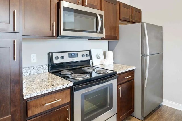 Stainless steel appliances with dark wood cabinets kitchen at Midtown Stillwater in Stillwater Student Accommodation
