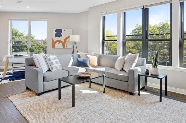 Gray sectional sofa with coffee tables and rug living room at Midtown Stillwater in Stillwater Student Accommodation