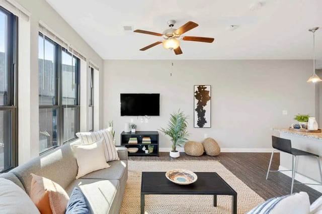 Sofa coffee table TV and ceiling fan living room at Midtown Stillwater in Stillwater Student Accommodation
