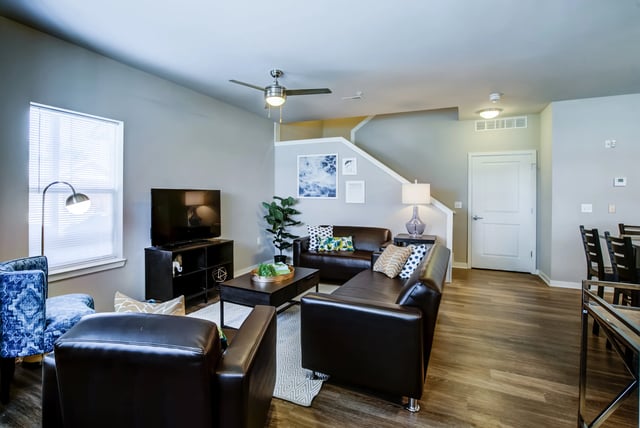 Brown leather couches and coffee table living room at Edge 1120 in Toledo Student Accommodation