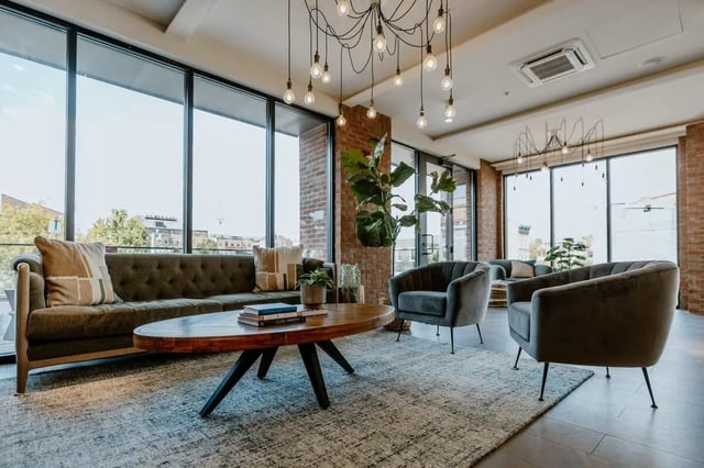 Sofa coffee table chairs plant living room at Industry Cincinnati in Cincinnati Student Accommodation